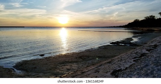 Sunset On Lake Ponchatrain, Southeast Louisiana. Clear Summer Skies Over Peaceful Waters. 