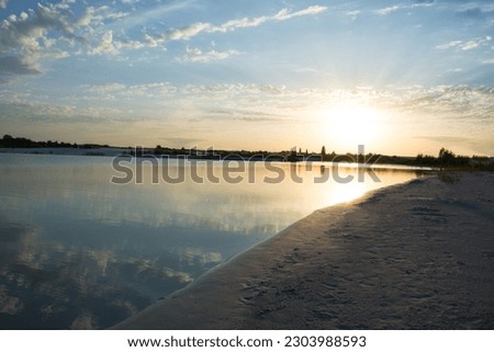 Sunset on the lake, reflection of the sky in the water