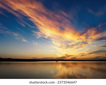 Sunset on the lake, reflections and colorful clouds - Powered by Shutterstock