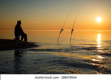 Sunset on  Lake Superior near Pictured Rock National Lake Shore Michigan State with silhouette of fisherman