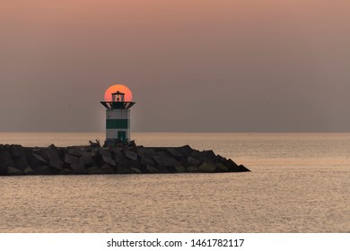 Sunset on the lighthouse of Scheveningen harbor at the summer hottest day ever