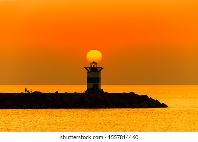 Sunset on the lighthouse of Scheveningen harbor at the summer hottest day ever, Netherlands