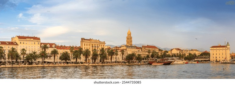 Sunset on the lively Riva promenade in Split, Croatia. Lined with palm trees and historic buildings, the waterfront is filled with people and colourful boats. - Powered by Shutterstock