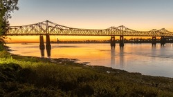 Sunset On The Mississippi River In Natchez, Mississippi With The Natchez Vidalia Bridge.