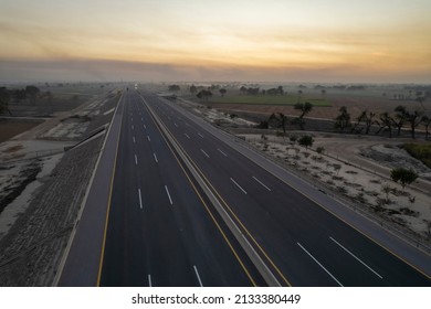 a sunset on the motorway - Shutterstock ID 2133380449
