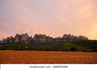 Sunset on the mountain of Montserrat, the most famous mountain in Catalonia.
Clouds in the sky completely orange. - Shutterstock ID 1840994284