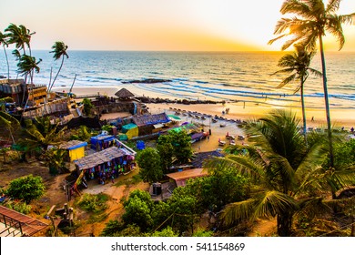 Sunset on palm beach on the Pacific Ocean, Goa, India