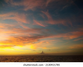 Sunset On Penghulu Agung Beach, Lombok, While Enjoying The View Of Mount Agung, Bali.