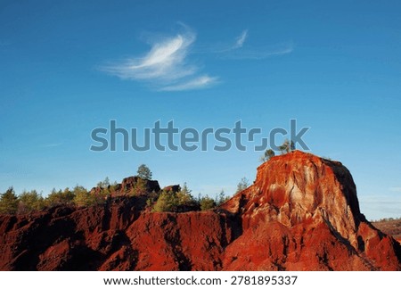 Sunset on the red cliffs of columnar basalts from Racos, Romania, Eastern Europe.