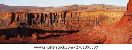 Sunset on the red cliffs of columnar basalts from Racos, Romania, Eastern Europe.