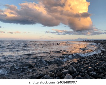 Sunset on the rocky beach by the ocean - Powered by Shutterstock