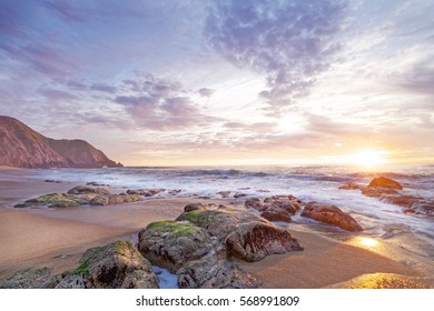 Sunset on a rocky beach, California coast, Half Moon Bay, Gray Whale Cove