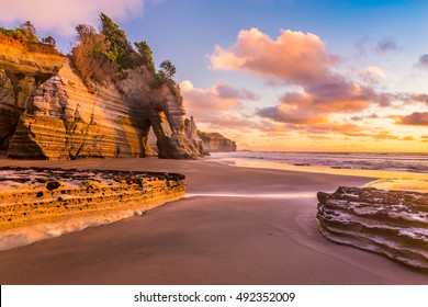 Sunset on a rocky beach in Taranaki district, New Zealand