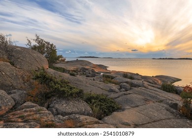 Sunset on the rocky seashore. Beautiful sunset sky. Photo - Powered by Shutterstock