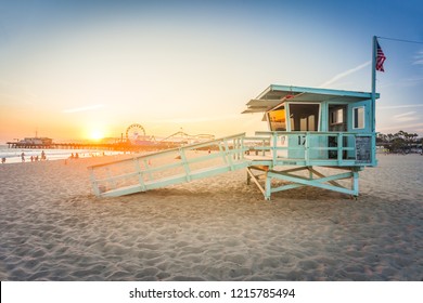 Sunset on Santa Monica beach with rescue cabin and amusement park on the background