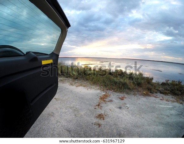 sunset on the sea with the\
car