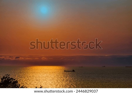 Sunset on sea level.Ever-changing, churning scenic clouds view. Beautiful sky light,shadow transitions and sailing ship like dreamland. Attractive serene landscape photography in kaohsiung port,Taiwan