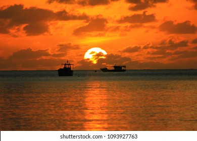 sunset on the sea of the seychelles island with shadow boat 