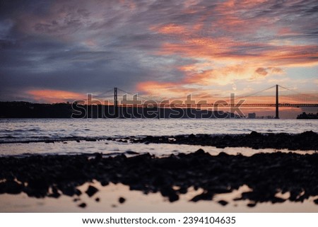 Sunset on Tagus river in Lisbon. View on Bridge