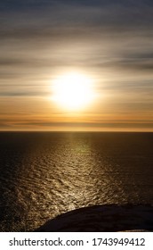 Sunset Over Arctic Ocean With A View Of Misty Clouds And Deep And Dark Sea Water In Greenland