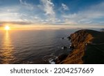 sunset over the Atlantic Ocean and the cliffs of Bray Head on Valentia Island in County Kerry of western Ireland