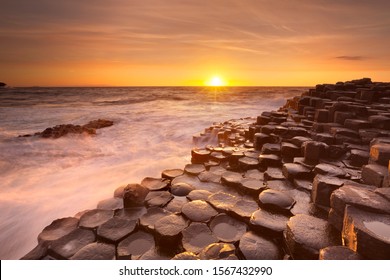 Sunset Over The Basalt Rock Formations Of Giant's Causeway On The North Coast Of Northern Ireland.