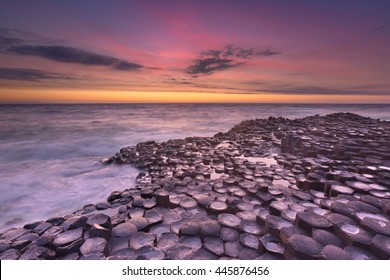 Sunset Over The Basalt Rock Formations Of Giant's Causeway On The North Coast Of Northern Ireland.