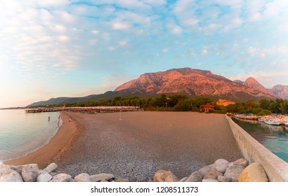 Sunset over the beach with mountains in the background. Summer holidays, beach holidays, relax