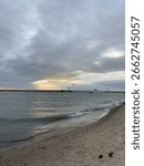 Sunset over the beach through the clouds