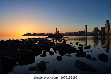 Sunset over Benidorm, view from the rocks and highlighting InTempo building, Hotel Bali and other buildings