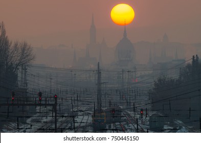 Sunset Over Budapest In Smog With Train Station