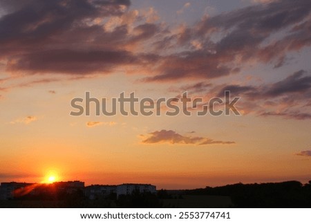Sunset over the city. Sunset sky clouds landscape, cityscape. Dramatic sky nature, golden hour. Cloudiness, cloudscape. Orange, yellow sundown sky, outdoors, evening time.