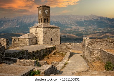 Sunset over clock tower and fortress at Gjirokaster, a beautiful town in Albania where the Ottoman legacy is clearly visible. High above the town the huge castle offers panoramic views.