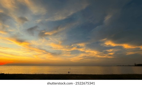 Sunset Over Coastal City Skyline with Vibrant Colors and Dramatic Clouds - Powered by Shutterstock