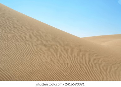 Стоковая фотография: Sunset over the desert of Al Khatim in Abu Dhabi, Emirates. Golden Sand Dune Desert Landscape Panorama. Beautiful sunset over the sand dunes in the Al Khatim in Abu Dhabi, Emirates