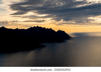 Sunset over the Devil's Teeth mountains of Senja Island and the Atlantic Ocean. View from Hesten Mount, Norway