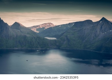 Sunset over the Devil's Teeth mountains of Senja Island and the Atlantic Ocean. View from Hesten Mount, Norway