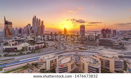 Sunset over Dubai Media City with Modern buildings aerial timelapse, United Arab Emirates. Dubai marina on a background with traffic on a road