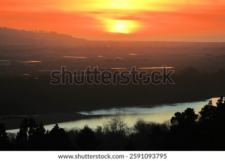 Sunset over the Eel River surrounded by a riparian woodland on the Northern California Coast taken at rural grasslands in Humboldt County near Eureka, CA