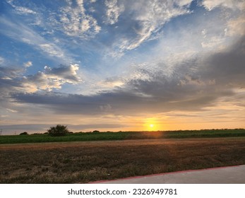 Sunset over a feild with clouds 