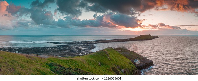 Sunset over Gower Peninsular Rhossilli Bay Worm Rock Formation red skies