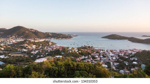 Sunset over the harbor of Charlotte Amalie in St Thomas with view over town and yachts in bay