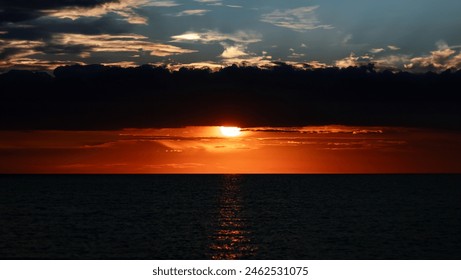 Sunset over horizon with dramatic clouds