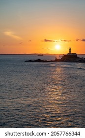 Sunset over the iconic Barra lighthouse (Portuguese: Farol da Barra) in Salvador, Bahia, Brazil, the oldest lighthouse in South America.