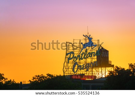 Sunset over the iconic Portland, Oregon Old Town sign in downtown Portland, Oregon