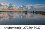 sunset over the lagoon inside the river Po delta with a dramatic sky in the background, Porto Levante, Rovigo, Italy
