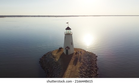 Sunset Over Lighthouse At East Wharf On Lake Hefner, Oklahoma City, Oklahoma, USA In Aerial View. A 36 Feet Tall Building Inspired By A 1700s New England Lighthouse