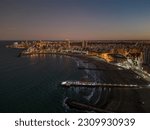 Sunset over Mar del Plata city in Buenos Aires Argentina. City skyline and beach on sunset and at night. Aerial drone shot