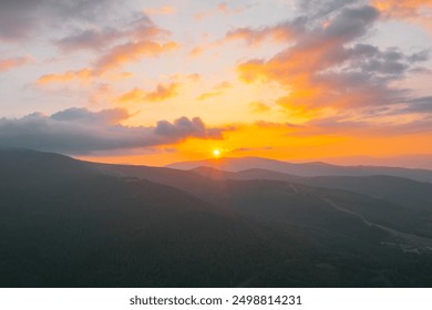 Sunset over mountain range with colorful clouds - Powered by Shutterstock