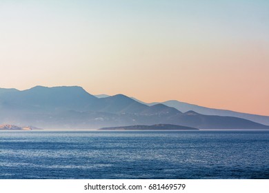 Sunset over the mountain, small island and the Mediterranean Sea. 